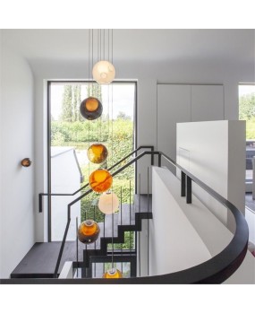 Creative designer of Bocci28 colored glass villa in Canada, dining room, duplex, cantilevered staircase, living room, chandelier